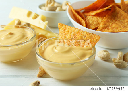 Snacks with cheese sauce on white wooden table Snacks with cheese sauce on white wooden table 87939952