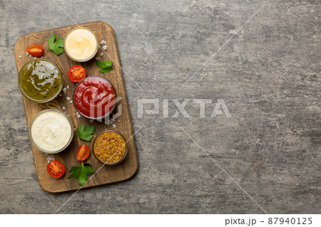 Many different sauces and herbs on table, flat lay top view. sauces on plate, healthy concept Many different sauces and herbs on table, flat lay top view. sauces on plate, healthy concept 87940125