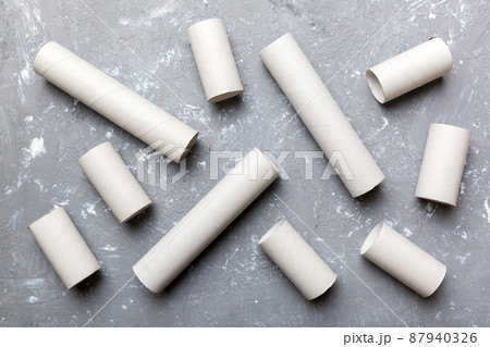 Empty toilet paper roll on colored background. Recyclable paper tube with metal plug end made of kraft paper or cardboard Empty toilet paper roll on colored background. Recyclable paper tube with metal plug end made of kraft paper or cardboard 87940326
