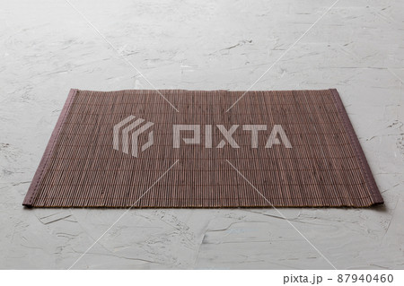 Perspective view of brown tablecloth for food on cement background. Empty space for your design 87940460