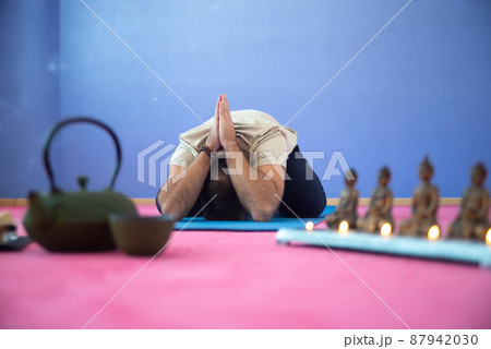 Spiritual man meditating in empty room 87942030