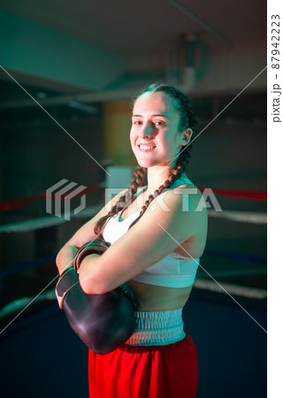 Portrait of happy girl standing on boxing ring 87942223