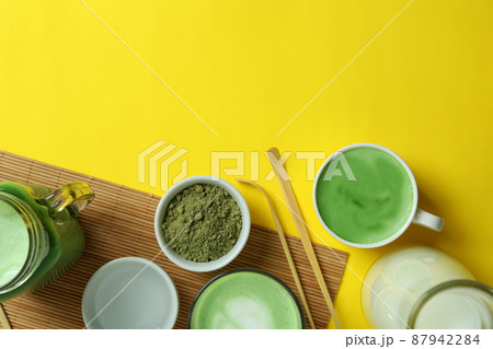 Matcha latte and accessories for making on yellow background 87942284
