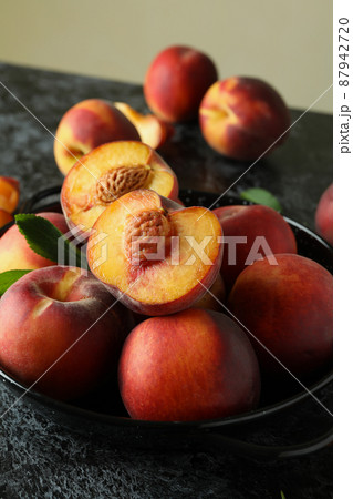 Bowl with peach fruits on black smokey table Bowl with peach fruits on black smokey table 87942720