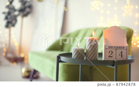 Christmas eve date. December 24 on wooden calendar standing on small tea table at home 87942878