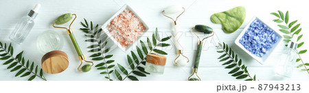 Skin care concept with face rollers on white wooden background Skin care concept with face rollers on white wooden background 87943213