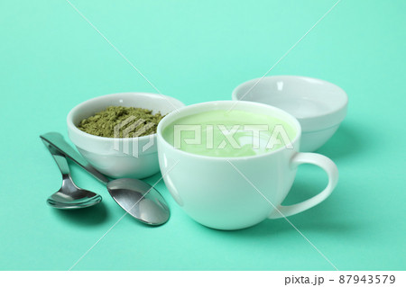 Cup of matcha green tea latte with accessories in background. Stock Photo  by ©Louno 156411208