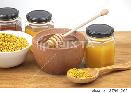 Fresh flower honey in a wooden bowl, spoon, pollen. vitamin food for health and life 87944262