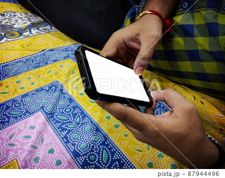 Asian Man's hand using a cellphone 87944496