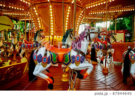 Horse carousel at amusement park 87944640