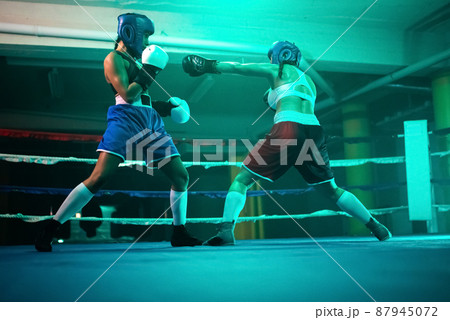 Sporty female boxers improving punches on ring 87945072