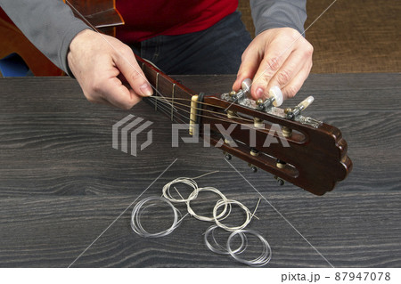 replacement and insertion of nylon strings in a classical guitar. lesson for a musician replacement and insertion of nylon strings in a classical guitar. lesson for a musician 87947078