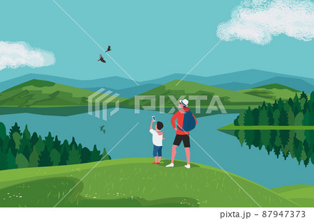 Father and son hiking together on lake hills 87947373