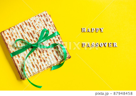 Celebrating the traditional Jewish holiday of Passover. Matzo on a yellow background. Pesach matzah. Celebrating the traditional Jewish holiday of Passover. Matzo on a yellow background. Pesach matzah. 87948458
