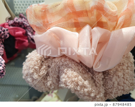 Set of trendy scrunchies, fluffy, satin and polyester fabric. Closeup 87948485
