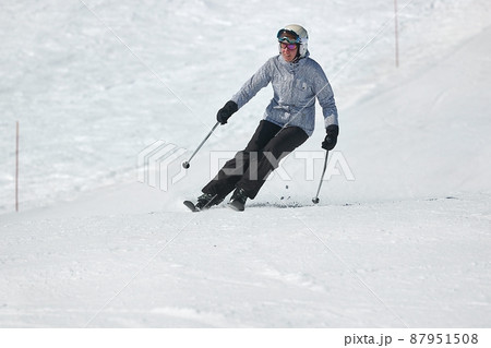 Skiing in the winter snowy slopes Skiing in the winter snowy slopes 87951508