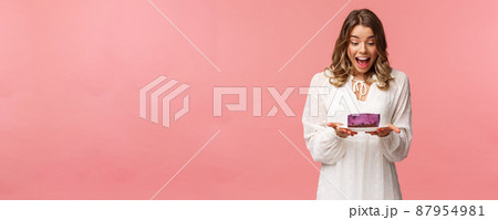 Holidays, spring and party concept. Portrait of happy and excited young blond girl decided start day with sweets, look amazed and cheerful and piece of delicious cake, cant wait to eat it Holidays, spring and party concept. Portrait of happy and excited young blond girl decided start day with sweets, look amazed and cheerful and piece of delicious cake, cant wait to eat it 87954981