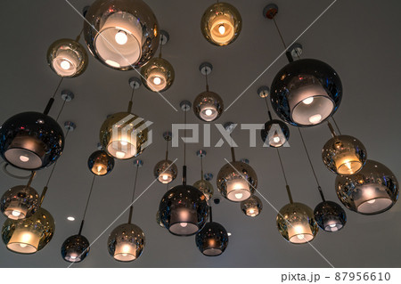 Beautiful luxury electric ceiling light lamp, group glass lamps, warm light from the lamps, worm eye view image. Beautiful luxury electric ceiling light lamp, group glass lamps, warm light from the lamps, worm eye view image. 87956610