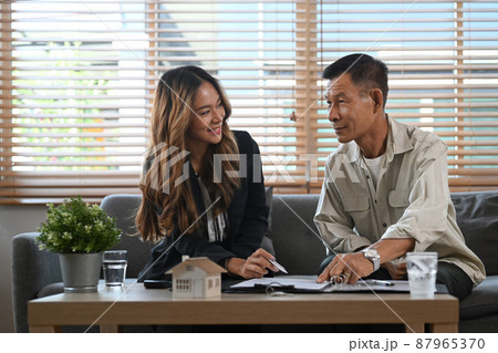 Elderly man meeting with financial advisor and discussing future property purchase contract terms. Elderly man meeting with financial advisor and discussing future property purchase contract terms. 87965370