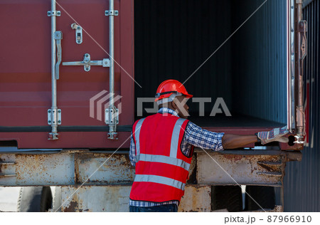 Foreman or worker work at Container cargo site check up goods in container. Foreman or worker work at Container cargo site check up goods in container. 87966910