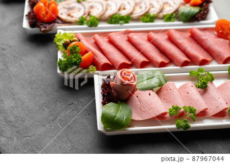 Platter of fresh meat cold cuts on table Platter of fresh meat cold cuts on table 87967044