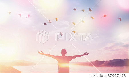 Happy backpack man raise hand up and birds flying on sunset sky at river background. Travel adventure and freedom feel good concept. Happy backpack man raise hand up and birds flying on sunset sky at river background. Travel adventure and freedom feel good concept. 87967198
