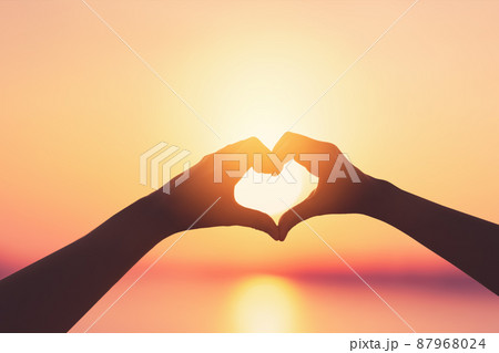 Female hands heart shape on sunset sky at tropical beach abstract background. Copy space of happy love travel and freedom in nature concept.  87968024
