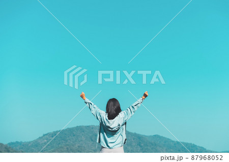 Copy space of woman hand raising on top of mountain and sunset sky abstract background. Freedom travel adventure and business victory concept. Copy space of woman hand raising on top of mountain and sunset sky abstract background. Freedom travel adventure and business victory concept. 87968052