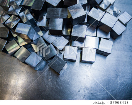 pile of small machined shiny steel cubes on metal surface pile of small machined shiny steel cubes on metal surface 87968413