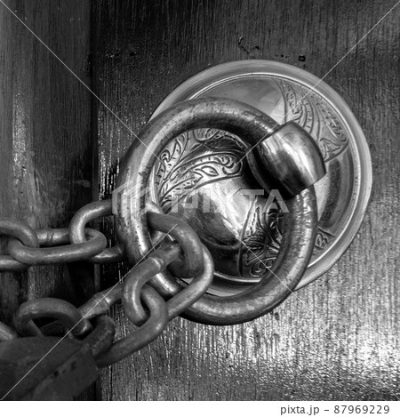 Antique copper ornate door knocker and rusted chain, Eyup Sultan Mosque, Istanbul, Turkey Antique copper ornate door knocker and rusted chain, Eyup Sultan Mosque, Istanbul, Turkey 87969229