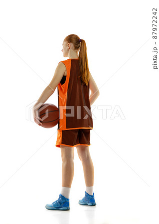 Back view full-length portrait of young sportive girl in brown unifrom posing isolated over white studio background Back view full-length portrait of young sportive girl in brown unifrom posing isolated over white studio background 87972242