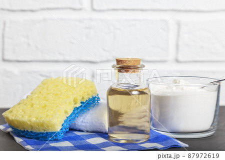 Apple cider vinegar, baking soda, scouring pad. Cleaning agent. Conceptual way for home cleaning 87972619