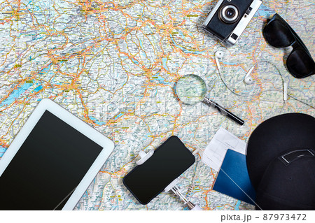 Travel plan, trip vacation accessories for trip, tourism mockup - Outfit of traveler on map background. Flat lay and copyspace. Travel plan, trip vacation accessories for trip, tourism mockup - Outfit of traveler on map background. Flat lay and copyspace. 87973472