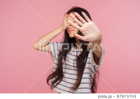 No, Don't want to watch, Portrait of displeased girl hiding eyes showing stop gesture, feeling disgusted by seen, refusing to look at shameful bad events, ignoring problem. indoor studio shot isolated 87973743