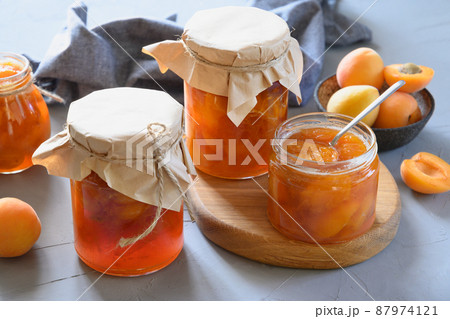 Apricot jam in glass jars. Summer harvest and canned food 87974121