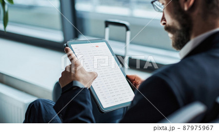 businessman studying a working document during a business trip . businessman studying a working document during a business trip . 87975967