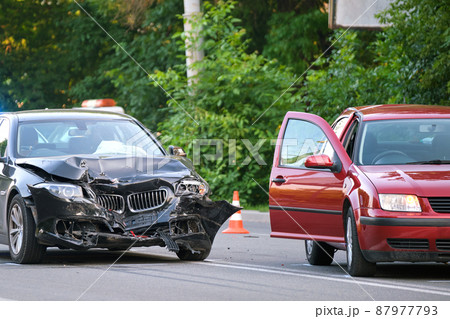 Damaged in heavy car accident vehicles after collision on city street crash site. Road safety and insurance concept. 87977793