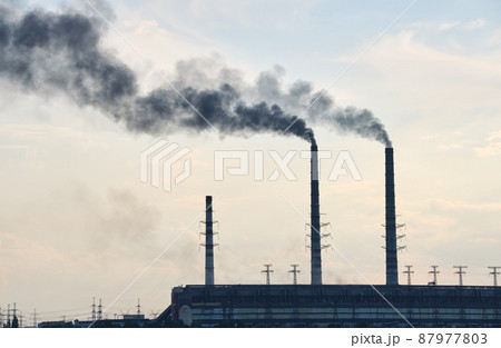 Coal power plant high pipes with black smoke moving upwards polluting atmosphere. Production of electrical energy with fossil fuel concept 87977803