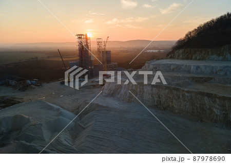 Cement factory at open pit mining of construction sand stone materials. Digging of gravel resources at quarry at sunset 87978690