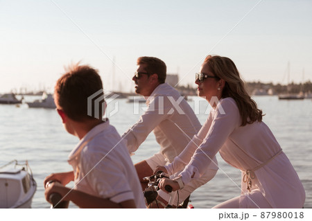Senior couple enjoying a beautiful morning together riding a bike by the sea. Selective focus 87980018