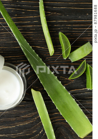 Aloe vera leaves, slices and cream on wooden background 87981688