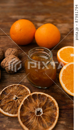 Sweet orange jam or marmalade dessert with walnuts on wooden background 87981794