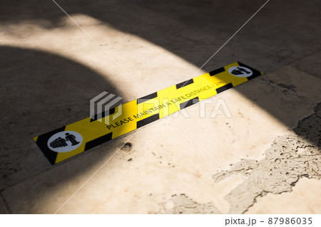 MAINTAIN A SAFE DISTANCE sign on the ground 87986035