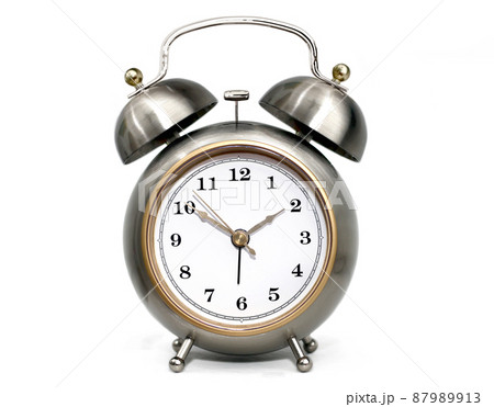 Metallic alarm clock with double bell on white background Metallic alarm clock with double bell on white background 87989913