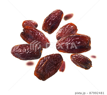 Dried dates levitate on a white background Dried dates levitate on a white background 87992481