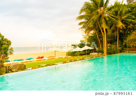 Umbrella and chair around swimming pool with sea ocean view 87993161