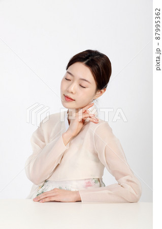 Asian Korean young woman wearing Hanbok Korean traditional clothes, beauty concept in studio Asian Korean young woman wearing Hanbok Korean traditional clothes, beauty concept in studio 87995362