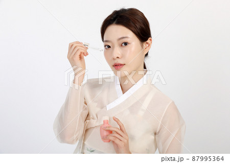 Asian Korean young woman wearing Hanbok Korean traditional clothes, beauty concept in studio Asian Korean young woman wearing Hanbok Korean traditional clothes, beauty concept in studio 87995364