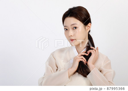 Asian Korean young woman wearing Hanbok Korean traditional clothes, beauty concept in studio Asian Korean young woman wearing Hanbok Korean traditional clothes, beauty concept in studio 87995366