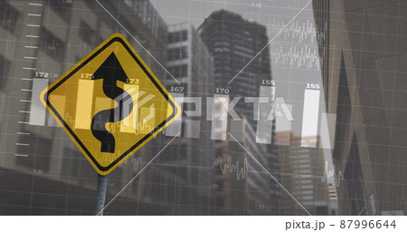 Image of financial data processing over road sign and cityscape 87996644